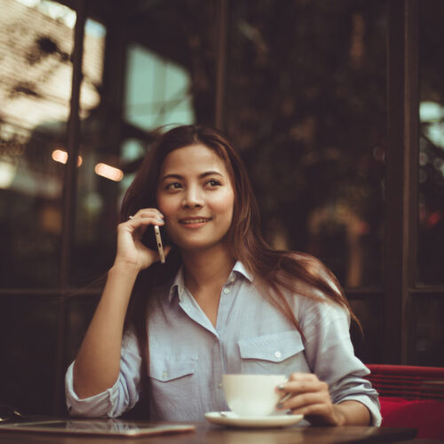 Asian woman drinking coffee in vintage color tone