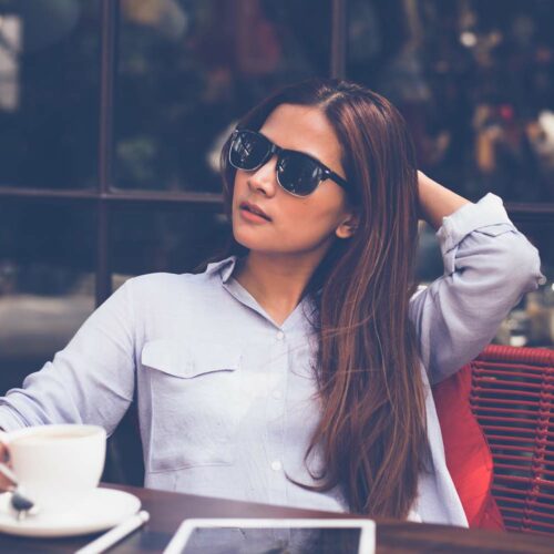 Asian woman drinking coffee in vintage color tone