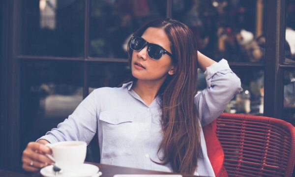 Asian woman drinking coffee in vintage color tone Asian woman drinking coffee in vintage color tone